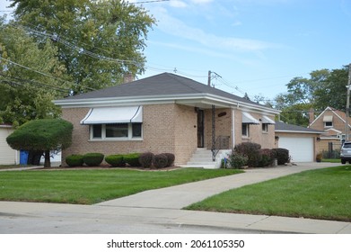 Beautfiul Brick Bungalow Single Family Home With White Awnings In Midwest USA