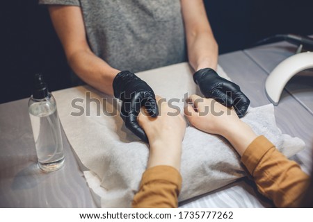 Beautician applying cream on client hands. Beauty salon. Hands Massage. Manicure at salon. Spa Manicure concept. Female hands with delicate manicure and moisturizing cream. Soft skin. Hand, beauty.
