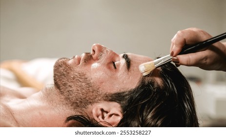 Beautician applying face mask to client in spa treatment - Powered by Shutterstock