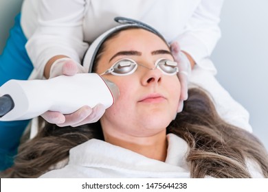 Beautician Applying Radio Frequency Microneedling Handpiece To A Woman's Face For Skin Tightening Treatments At A Beauty Clinic.