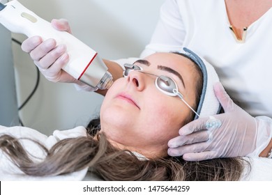 Beautician Applying Radio Frequency Microneedling Handpiece To A Woman's Face For Skin Tightening Treatments At A Beauty Clinic.