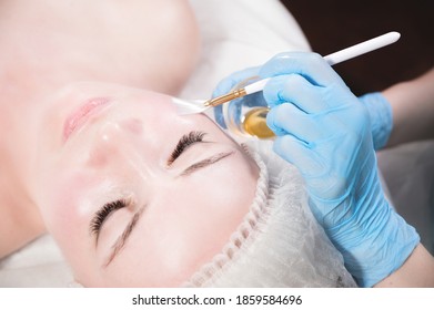 Beautician in a beauty salon puts a protective mask on the client's face. Facial skin care and beauty treatments - Shutterstock ID 1859584696