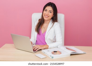 beautician doctor, successful entrepreneur woman, smiling. aesthetic professional, businesswoman. typing on notebook, looking at camera. - Powered by Shutterstock