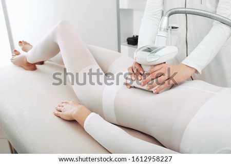 Beautician doing a beautiful figure for a woman, using the LPG apparatus.