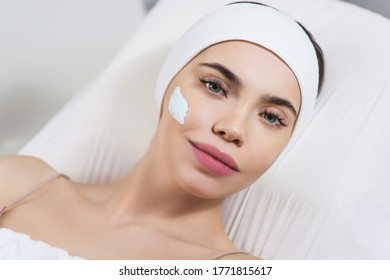 Beautician doing facial skin cleansing of a young woman using cream in a beauty clinic or spa salon. Cosmetology treatment. Perfect skin concept. Eternal youth. - Shutterstock ID 1771815617