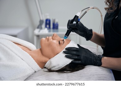Beautician doing facial skin rejuvenation for pretty female - Shutterstock ID 2279677615