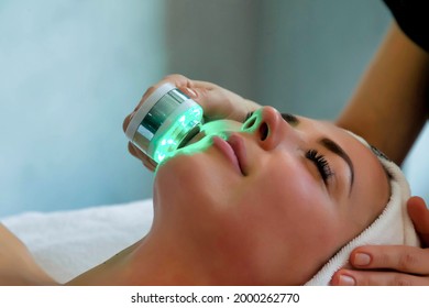 Beautician doing led light therapy to woman in SPA salon, facial phototherapy for skin pore cleaning. Anti-aging treatments and photo rejuvenation procedure. Lady getting face therapy in SPA resort - Shutterstock ID 2000262770
