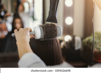 Beautician drying woman's hair after giving a new haircut at salon. Beauty, care, hair cocnept