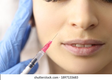 Beautician gives woman an injection in face. Meseotherapy for face concept