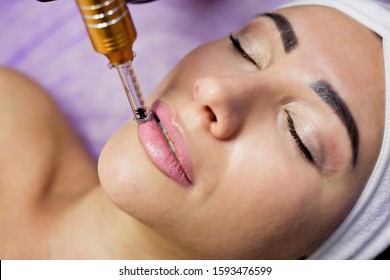 Beautician makes injection of mesotherapy to the patient. Microneedle mesotherapy. Treatment of a woman by a beautician. Hardware cosmetology. Mesotherapy, facial area treatment, facial rejuvenation. 