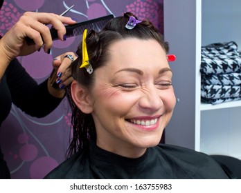 Beautician Making New Hair Style To Mature Woman In Salon