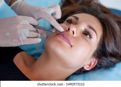 Beautician And Patient In Aesthetic Medicine Clinic. Lip Injection