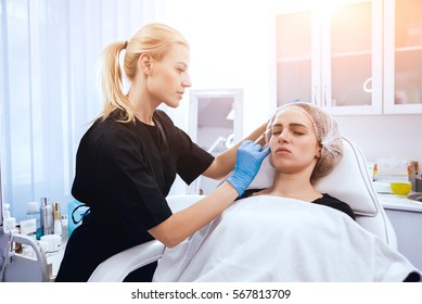 Beautician and the patient in the clinic of aesthetic medicine. The injection.