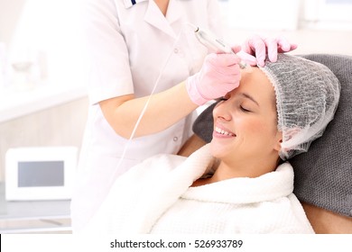 Beautician Performs A Needle Mesotherapy Treatment On A Woman's Face