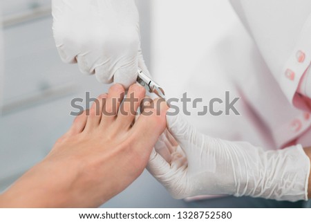 Beautician trimming clients Toenail. Hygienic Manicure Process