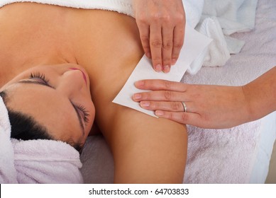 Beautician Waxing Armpit To A Woman In A Salon