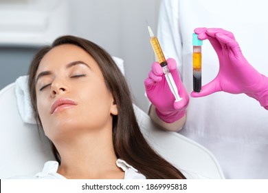 Beautician will do PRP therapy for the face against wrinkles. She has blood plasma for injections and a syringe with plasma in her test tube. Cosmetology in the beauty salon.