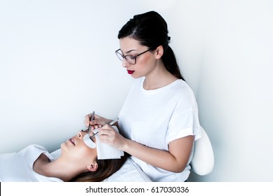 Beautician Working On Upgrading Silk Eyelashes In A Beauty Studio