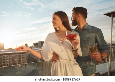 Beautidul elegant couple looking at the city views from restaurant terrace, copy space - Powered by Shutterstock