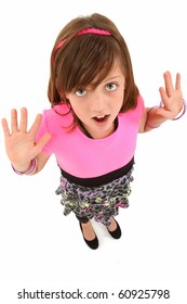 Beautiful 10 year old girl with hands out and surprised expression over white.  Top view.