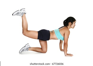 Beautiful 30 year old Filipino woman in workout clothes  exercising over white background.