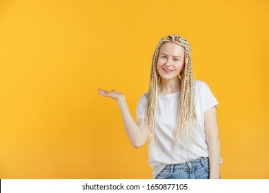 Beautiful 30 Year Old Woman With Braids Kanekalon Hairstyle Point To Copy Space On Yellow Background