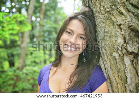 Beautiful 30 years old woman standing in forest