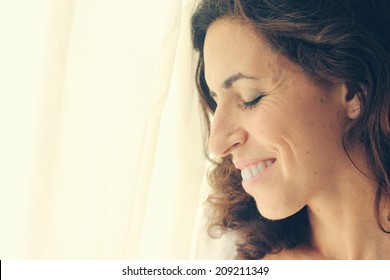 Beautiful 35 Year Old Woman Stands Near The Window