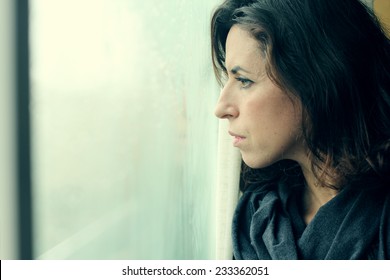 beautiful 35 year old woman stands in front of the window