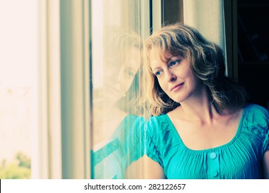 Beautiful 35 Year Old Woman Stands In Front Of The Window