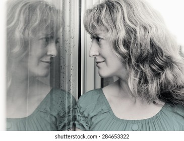 Beautiful 35 Year Old Woman Stands In Front Of The Window