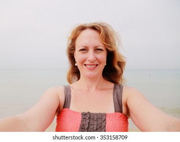 Beautiful 35 Years Old Woman Standing On The Shore Of The Beach. Selfie