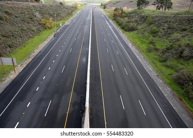 A Beautiful 6 Lane Highway On A Toll Road In Orange County California With Cars And Green Valley Walls On Both Sides