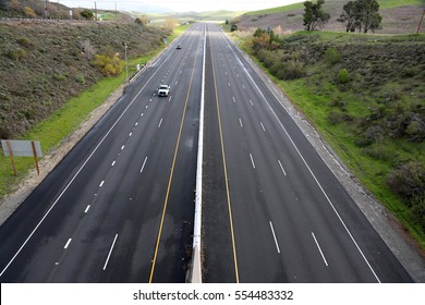 A Beautiful 6 Lane Highway On A Toll Road In Orange County California With Cars And Green Valley Walls On Both Sides