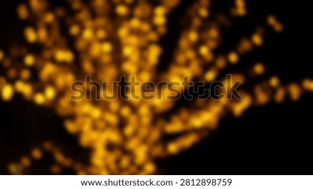A beautiful abstract background featuring blurred golden orange bokeh lights creating a festive and magical atmosphere.
