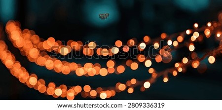 A beautiful abstract background featuring soft, out-of-focus orange bokeh lights creating a warm and festive atmosphere.
