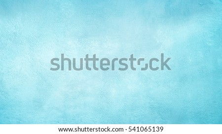 Beautiful Abstract Grunge Decorative Light Blue Cyan Painted Stucco Wall Texture. Handmade Rough Winter Christmas Paper Wide Background With Copy Space
