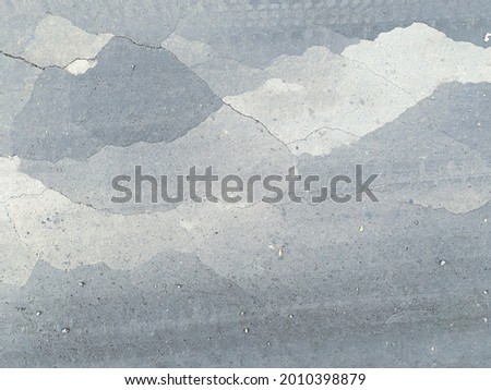 beautiful abstract grungy gray-blue background in a cold mood. Dust and dirt compacted by the wheels of cars, country road. Copy space
