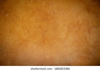 Beautiful abstract grungy yellow- orange stucco wall background in warm mood