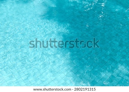 Beautiful abstract pattern created by sunlight and shadows on a clean swimming pool surface. Excellent background for travel advertising, wellness campaigns, hospitality branding, summer promotions and luxury lifestyle projects.