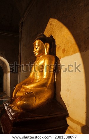 Beautiful Acient Bagan Golden Buddhist Statue with sun lighting and shadow