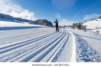 beautiful active senior woman cross-country skiing in fresh fallen powder snow in the Allgau alps near Immenstadt, Bavaria, Germany - Powered by Shutterstock