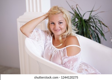 beautiful adult blonde girl posing in the bathroom and relaxing