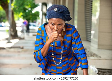 Beautiful Adult Businesswoman Standing In Traditional Loincloth And Coughing Outside.