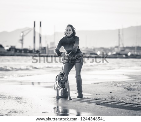 Similar – Image, Stock Photo Young woman with pipe backlit by the sea in the midnight sun