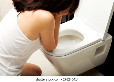 Beautiful Adult Woman Vomiting In Toilet.