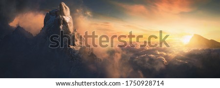Beautiful aerial landscape of mountain peak at sunset above the clouds - panoramic Foto d'archivio © 