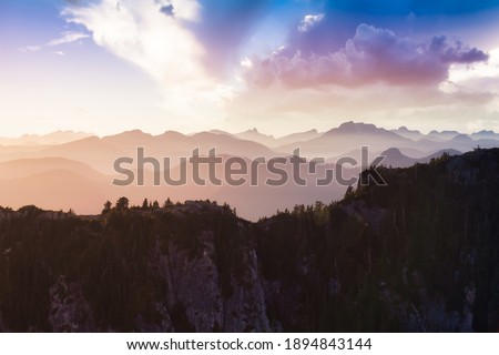 Beautiful aerial landscape view of Mountain Peaks near Vancouver, British Columbia, Canada. Colorful Cloudy Sunset Sky Art Render.