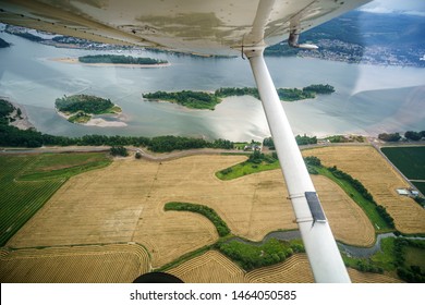 Beautiful Aerial Photo From A Small Plane Over The Columbia River Near Portland, Oregon. Weather Is Cloudy And Raining.