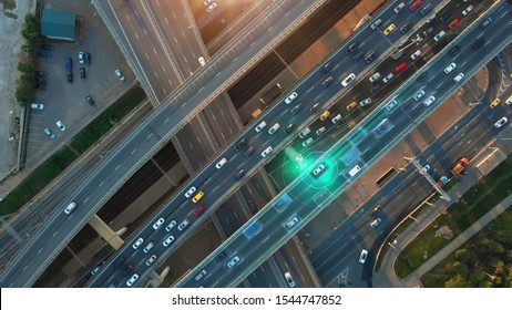 Beautiful aerial presentation of the autonomous cars self-driving concept on multi-level highway in Moscow. Direct view from above to the road traffic in a big city on the sunny evening.